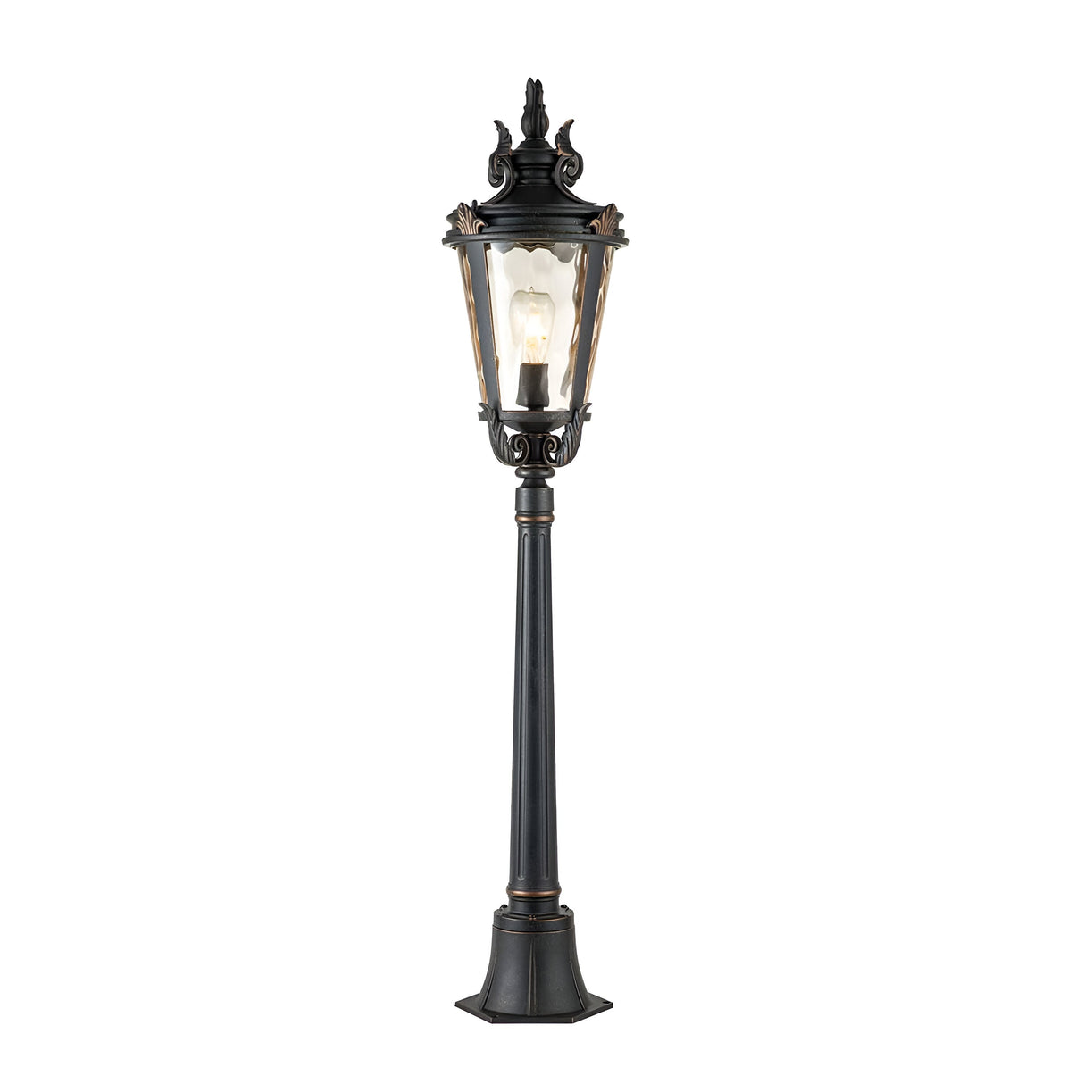 The Baltimore 1 Light Medium Pillar in weathered bronze boasts a classic design with its ornate street lamp style, featuring a tall post and decorative top. Its clear glass enclosure elegantly reveals the light bulb inside, making it perfect for outdoor lighting with its timeless charm.