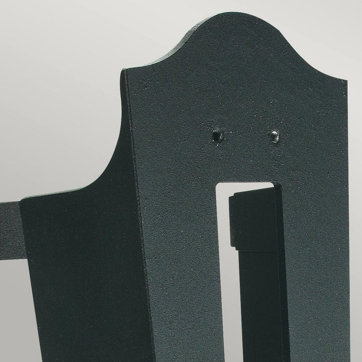 A close-up of the Corner Bracket 4 - Black, featuring a dark green, textured metal panel resembling a lantern-style fixture. It has a curved top with a rectangular cutout in the center and two small holes above the cutout. The background is a plain light gray.