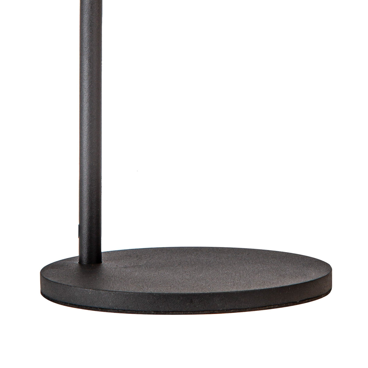 Close-up of the matt black circular metal base and curved stem of the Capuccina Small LED table lamp on a white background.