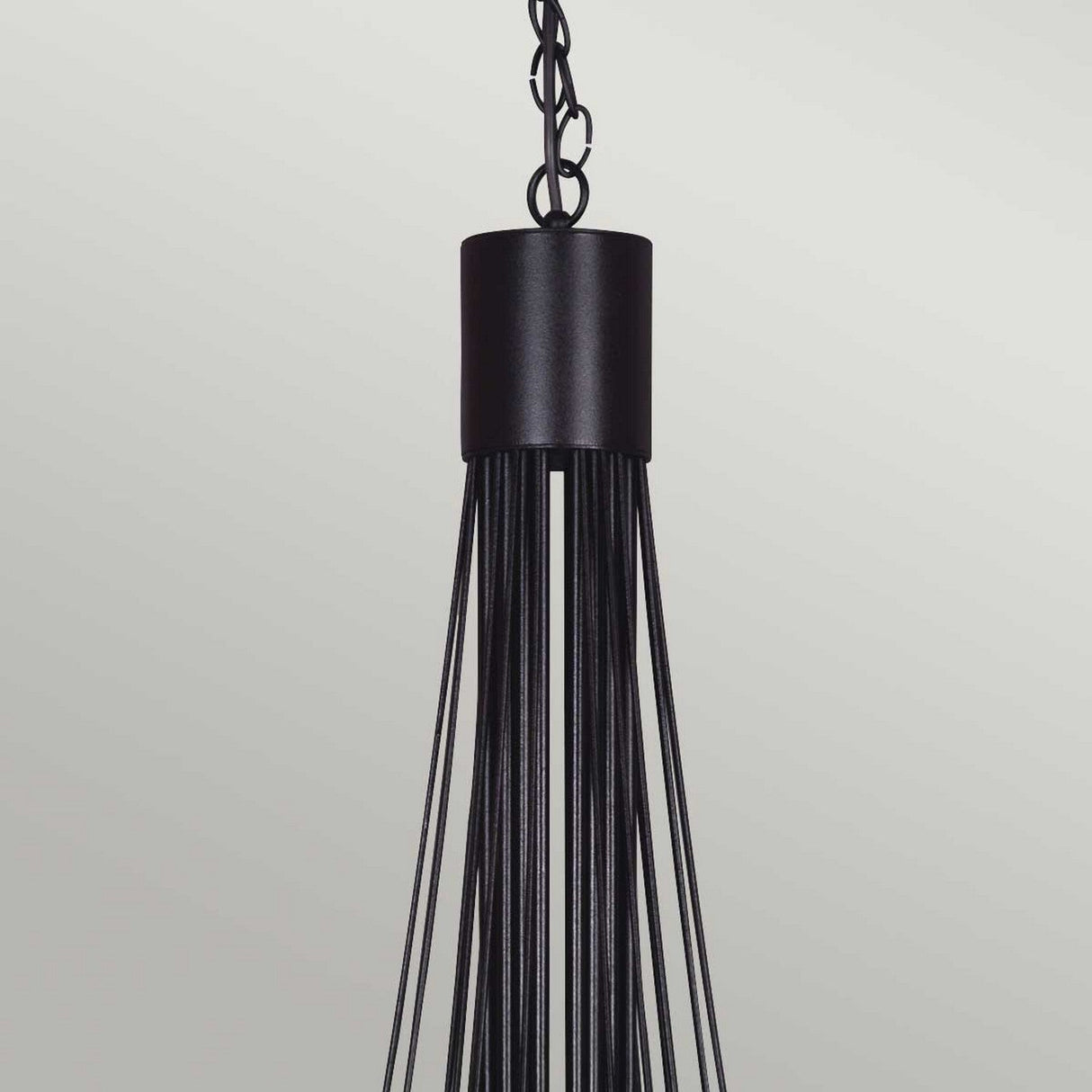 The Carisbrooke 18 Light Chandelier in Black features a modern design with a cylindrical top and multiple slim, elongated rods that evoke the elegance of a candelabra-style fixture, offering a sleek and contemporary look against a neutral background.