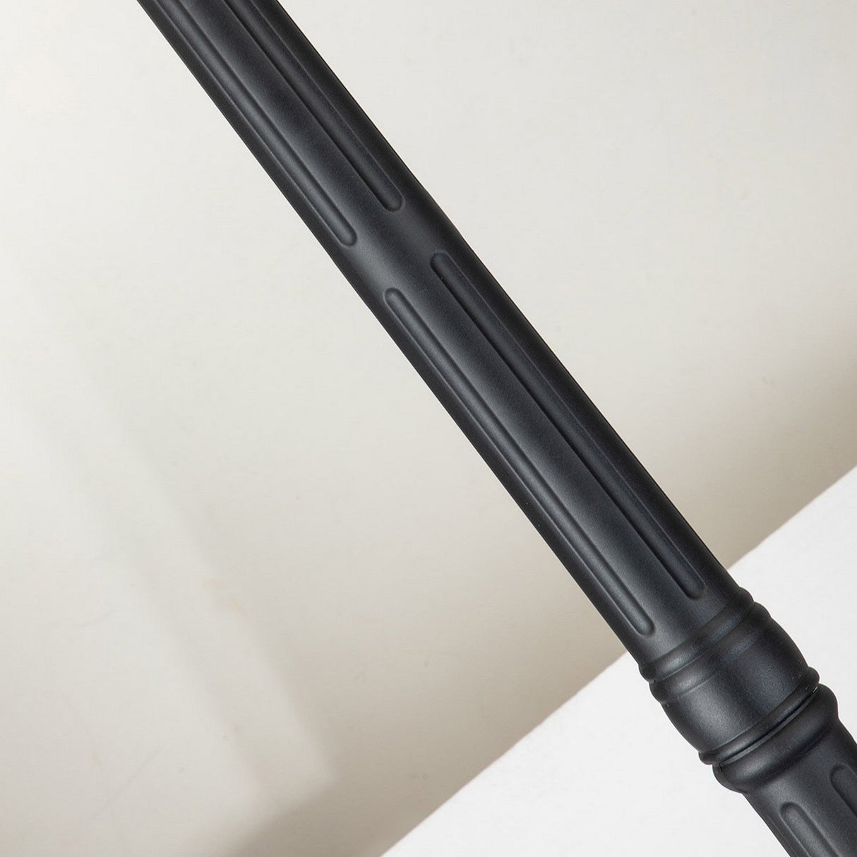 Diagonal view of the Chicago Single Head Lamp Post - Black with its ribbed metal design evoking vintage street lamps, set against a light grey background.