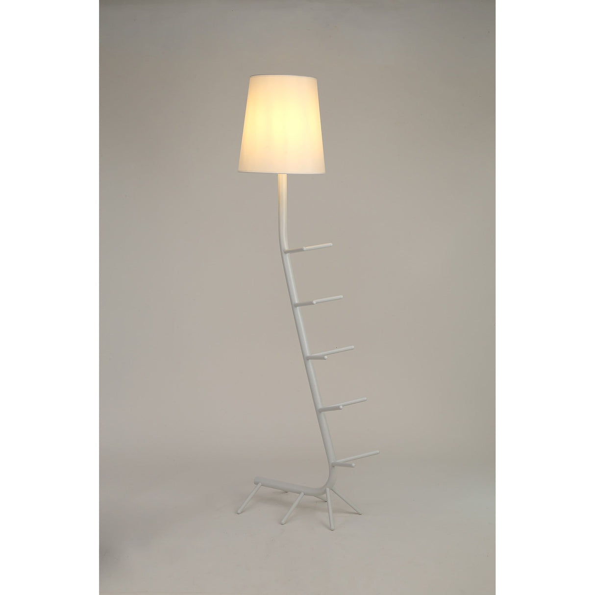 The Centipede 1 Light Floor Lamp features a white base with ladder-like rungs and a glowing white shade, bringing sculptural style and soft ambient lighting to any modern space.