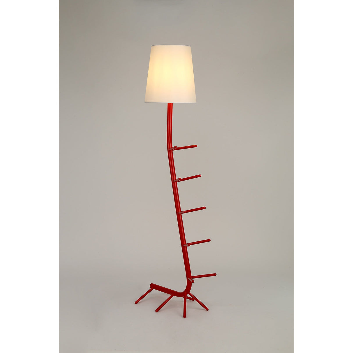The Centipede 1 Light Floor Lamp features a modern red, branch-like base with angled protrusions and a white shade, shown against a plain light background.
