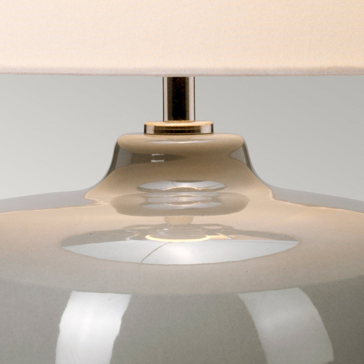 Close-up of the Chalk Farm Table Lamp, featuring a sleek ceramic vase base in light grey and chalk white paired with a cream-colored faux silk shade. The metallic rod connecting the base to the shade is topped with a polished nickel finial, all set against a neutral background.