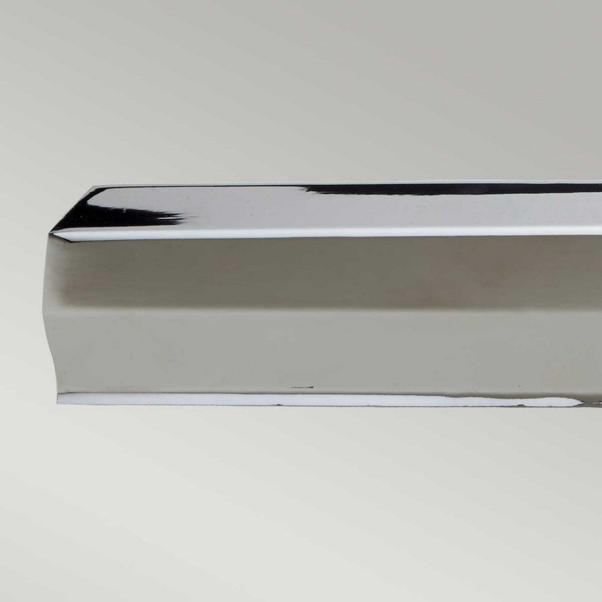 A close-up of the Chawton Large Picture Light in polished nickel, featuring its flat surface and beveled edge, set against a plain light gray background. The metal reflects light with modern design elegance, showcasing its clean and polished appearance.