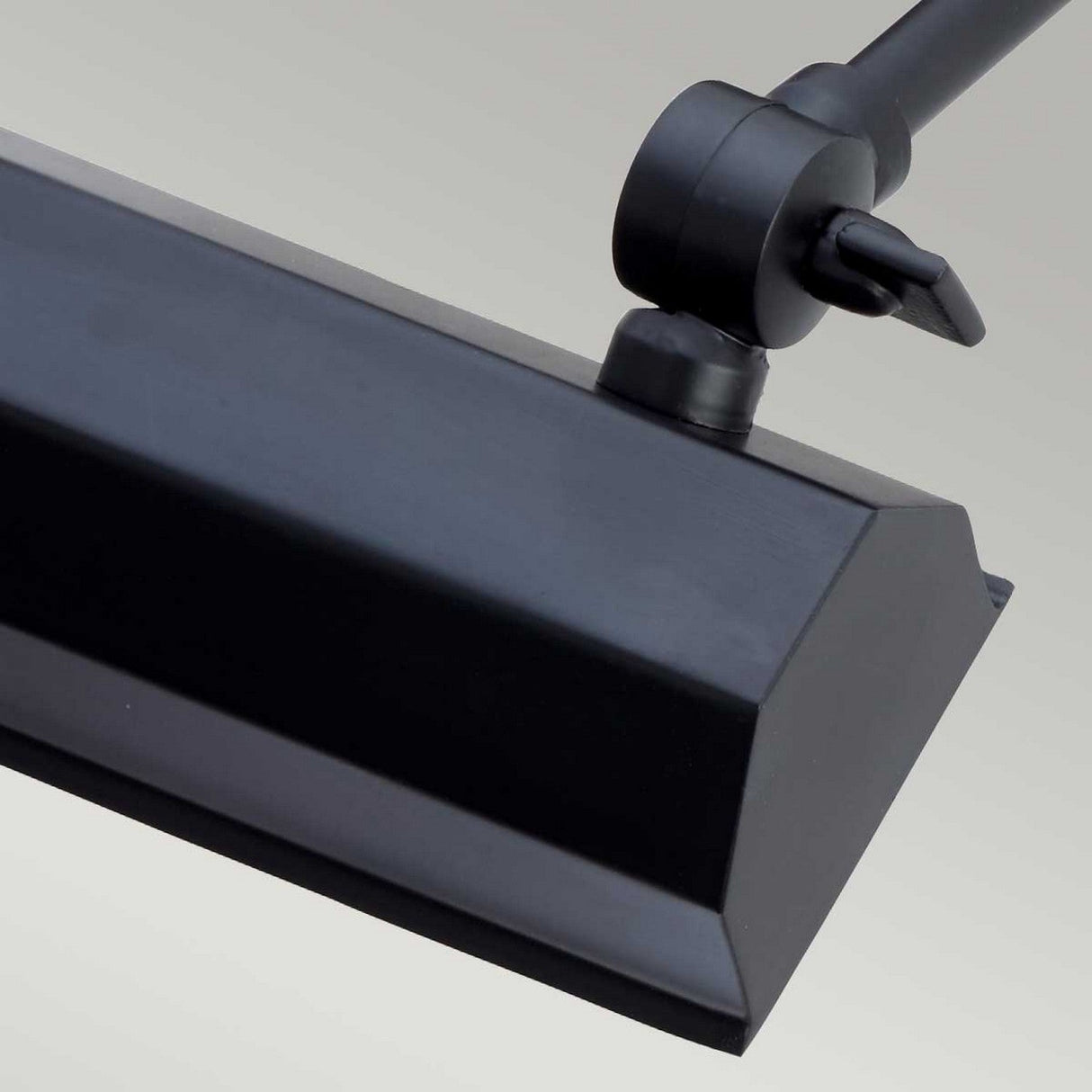 Close-up of the Chawton Small Picture Light in black, showcasing a matte, rectangular fixture with adjustable knuckle joints against a neutral background. The angular design of this light is ideal for modern décor, providing precise lighting direction.