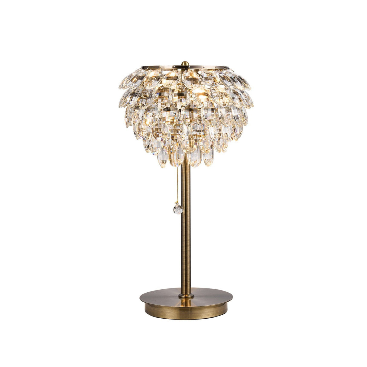 The Coniston 2 Light Crystal Table Lamp in Antique Brass features a round base and a layered, teardrop crystal shade for an elegant, luxurious look.