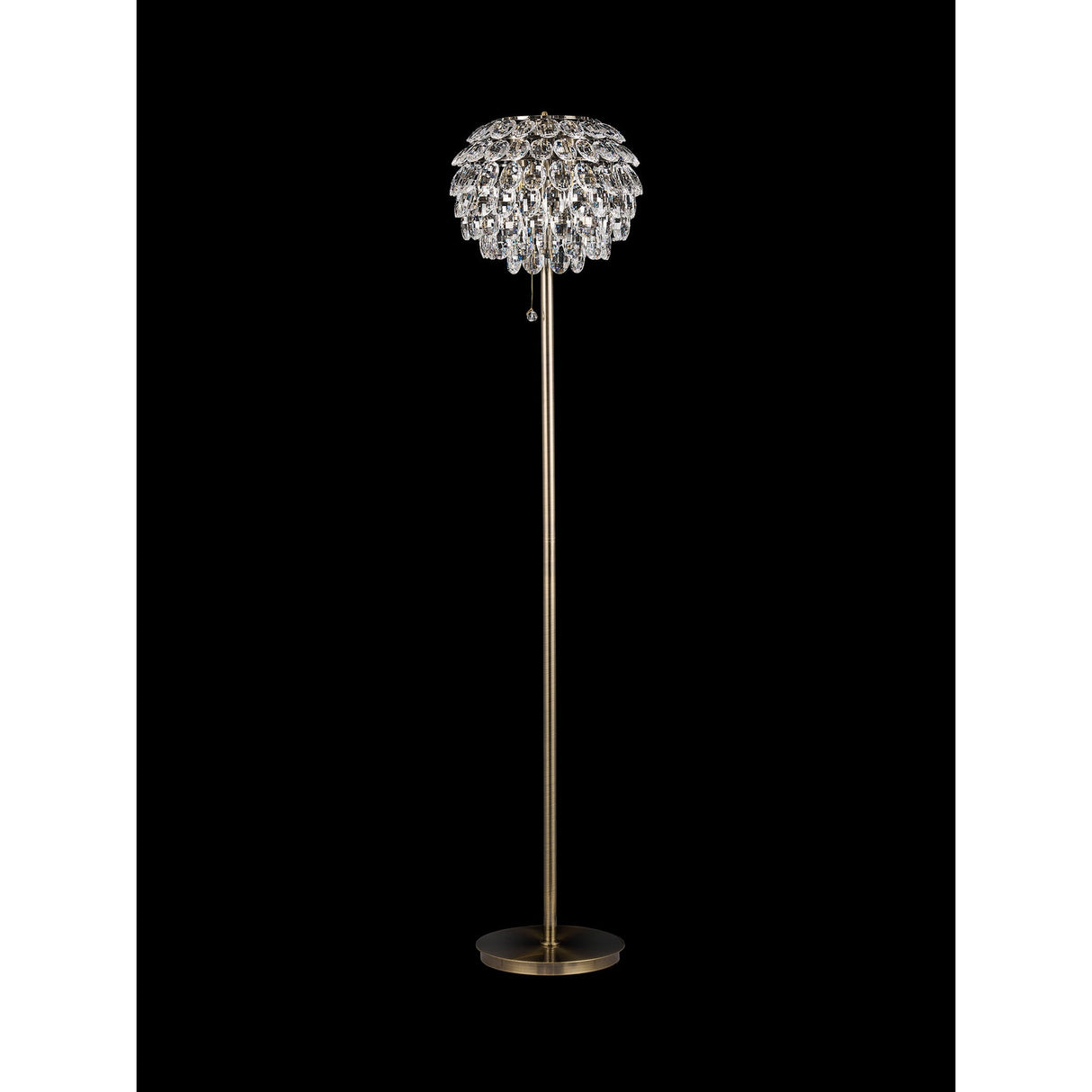 The Coniston 3 Light Crystal Floor Lamp in antique brass features a slender stand and a crystal-covered shade resembling cascading petals, shown against a black background.