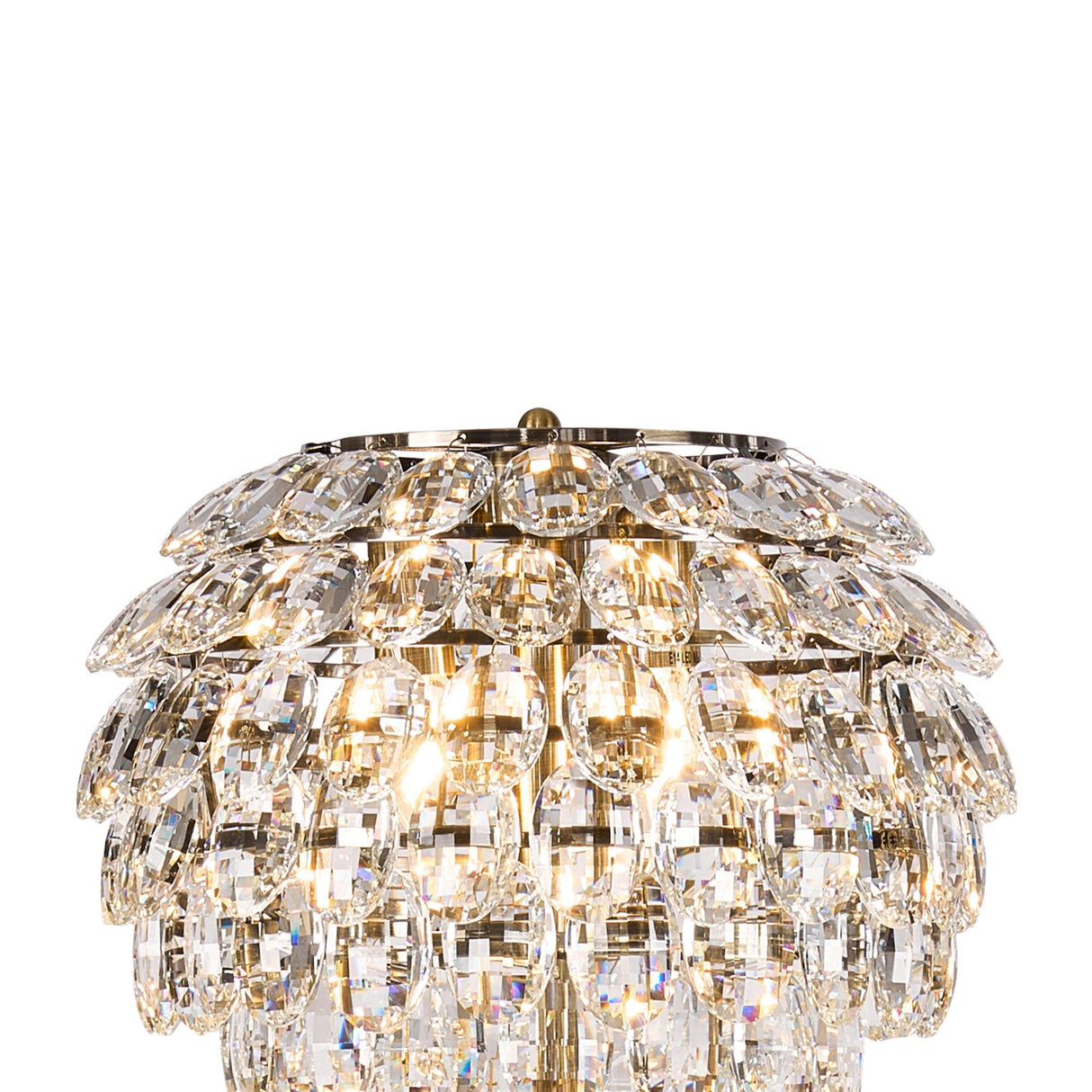 A close-up of an opulent chandelier with overlapping rows of clear crystal prisms and warm lights—perfectly complemented by the Coniston 3 Light Crystal Floor Lamp in Antique Brass for added vintage elegance.