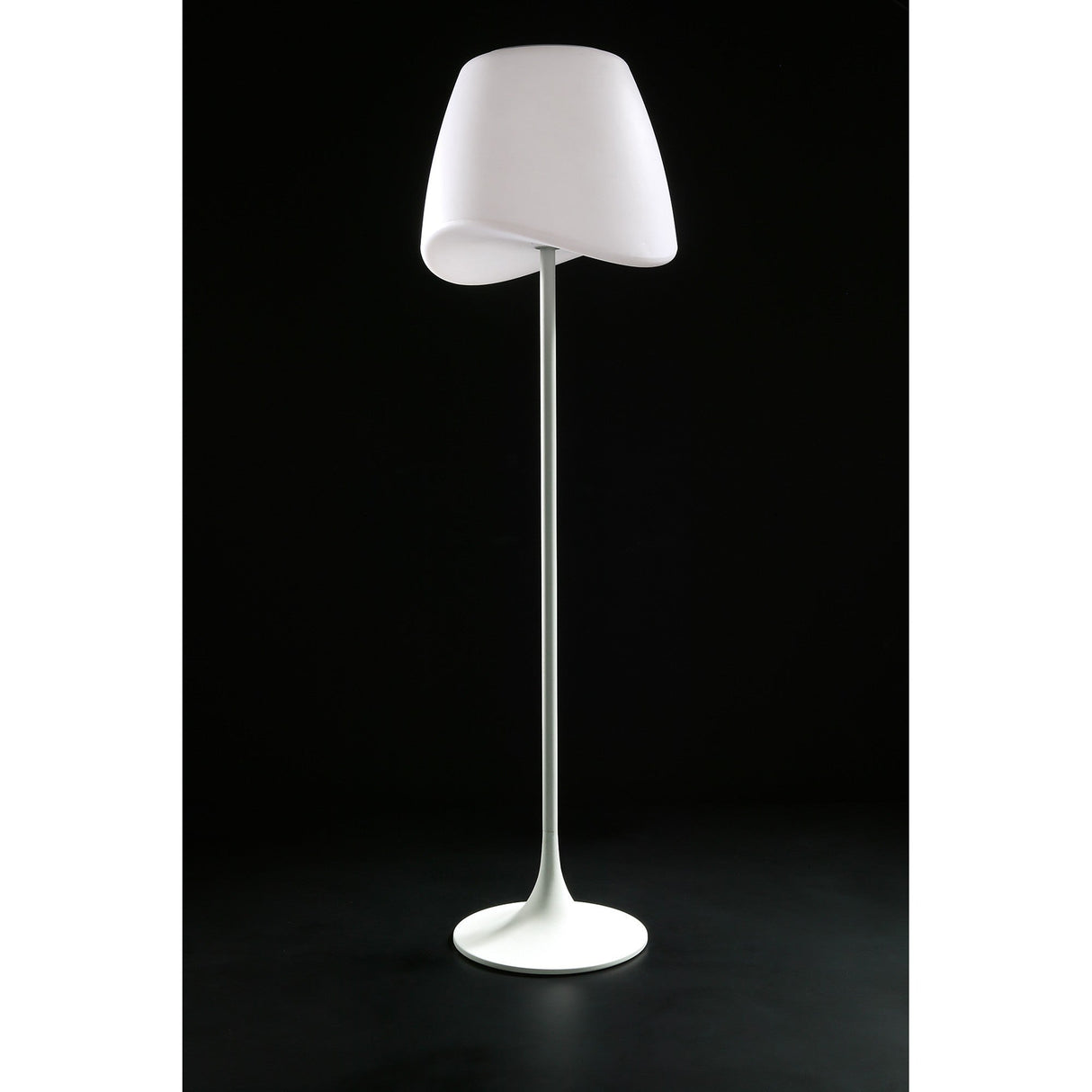 The Cool 2 Light Floor Lamp in matt white and opal white stands on a round base with a gently angled shade, glowing softly against a black background for ambient lighting.