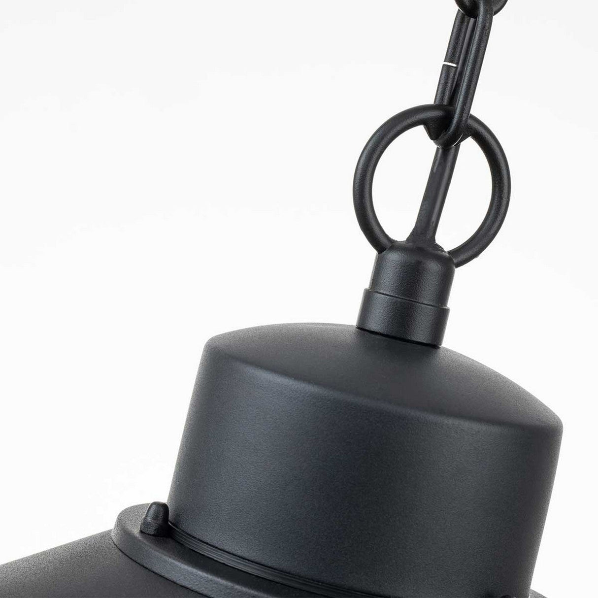 Depicted is a close-up of the Copenhagen Outdoor 1 Light Chain Pendant in black, showcasing its matte black, industrial-style design. The pendant features a chain link attachment on a white background and echoes Danish design with its cylindrical top section and circular hanging loop, making it ideal for illuminating coastal regions.