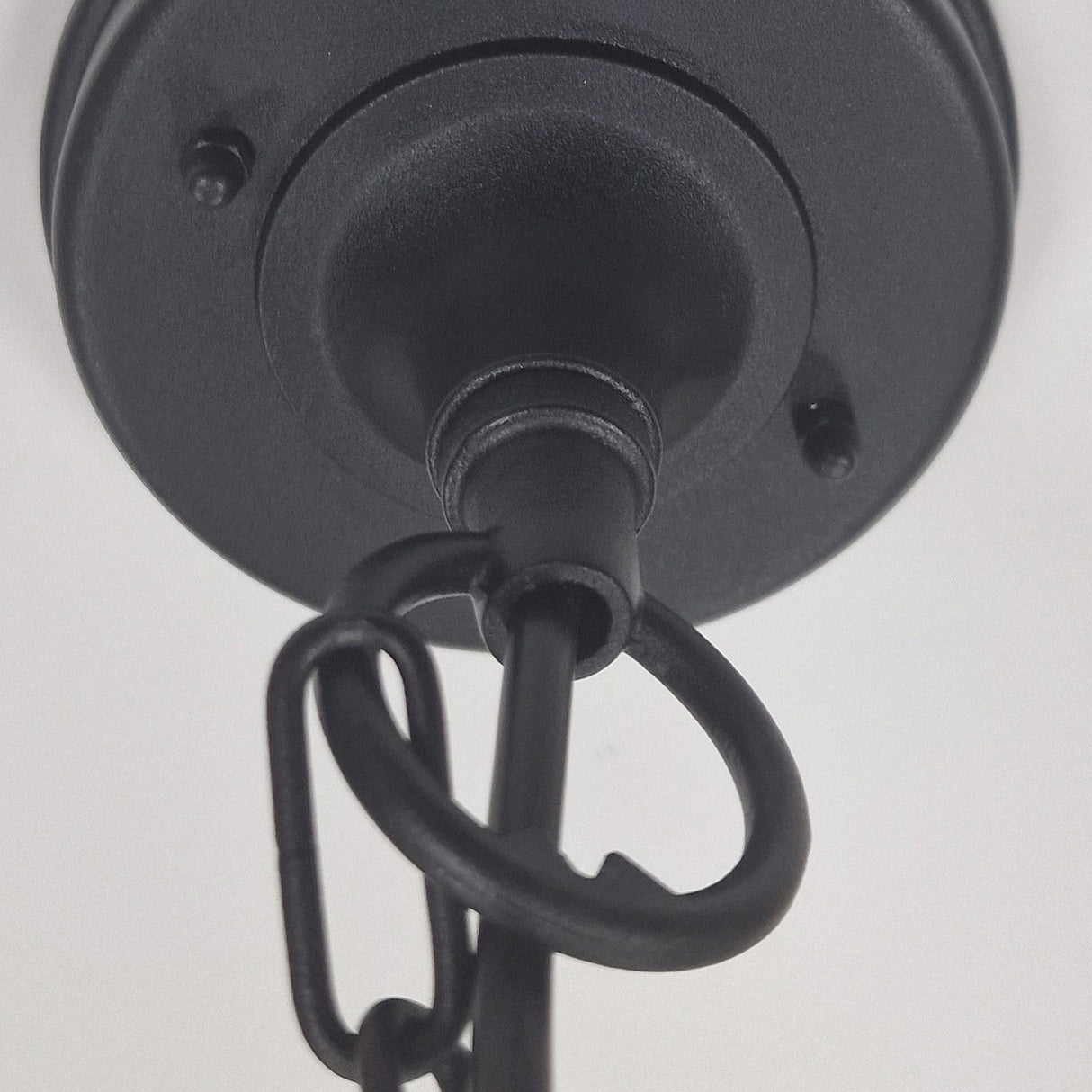 Close-up view of the Chapel 1 Light Outdoor Chain Pendant in black, featuring a circular base and connected chain link crafted from die-cast aluminum. Designed for outdoor use, it boasts an IP44 rating and is set against a white background.