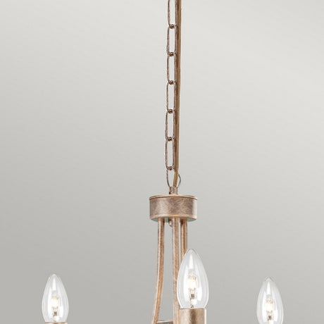 Close-up of the Christina 3 Light Chandelier - Silver/Gold Patina, featuring a metal chain and three candle-like bulbs, adorned with crystal drops and boasting a stunning Silver and Gold patina finish, set against a plain background.