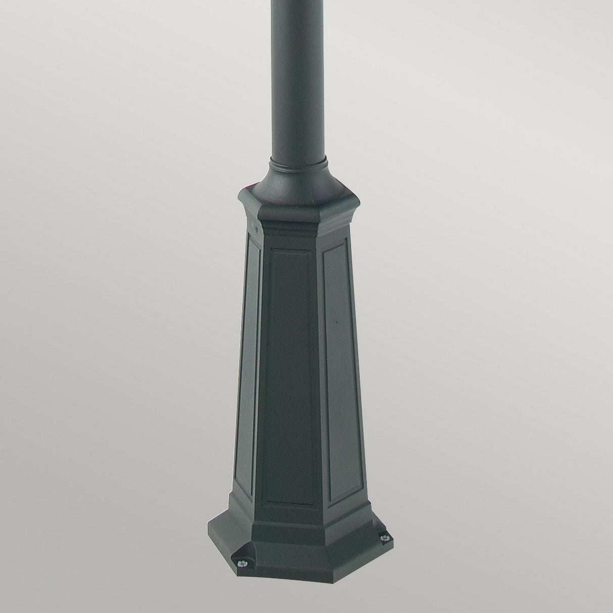 The Chelsea Twin Head Lamp Post - Copper & Black features a hexagonal black metal base with subtle paneling, making it ideal for outdoor lighting. Its striking copper and black finish stands out beautifully against a plain white background.