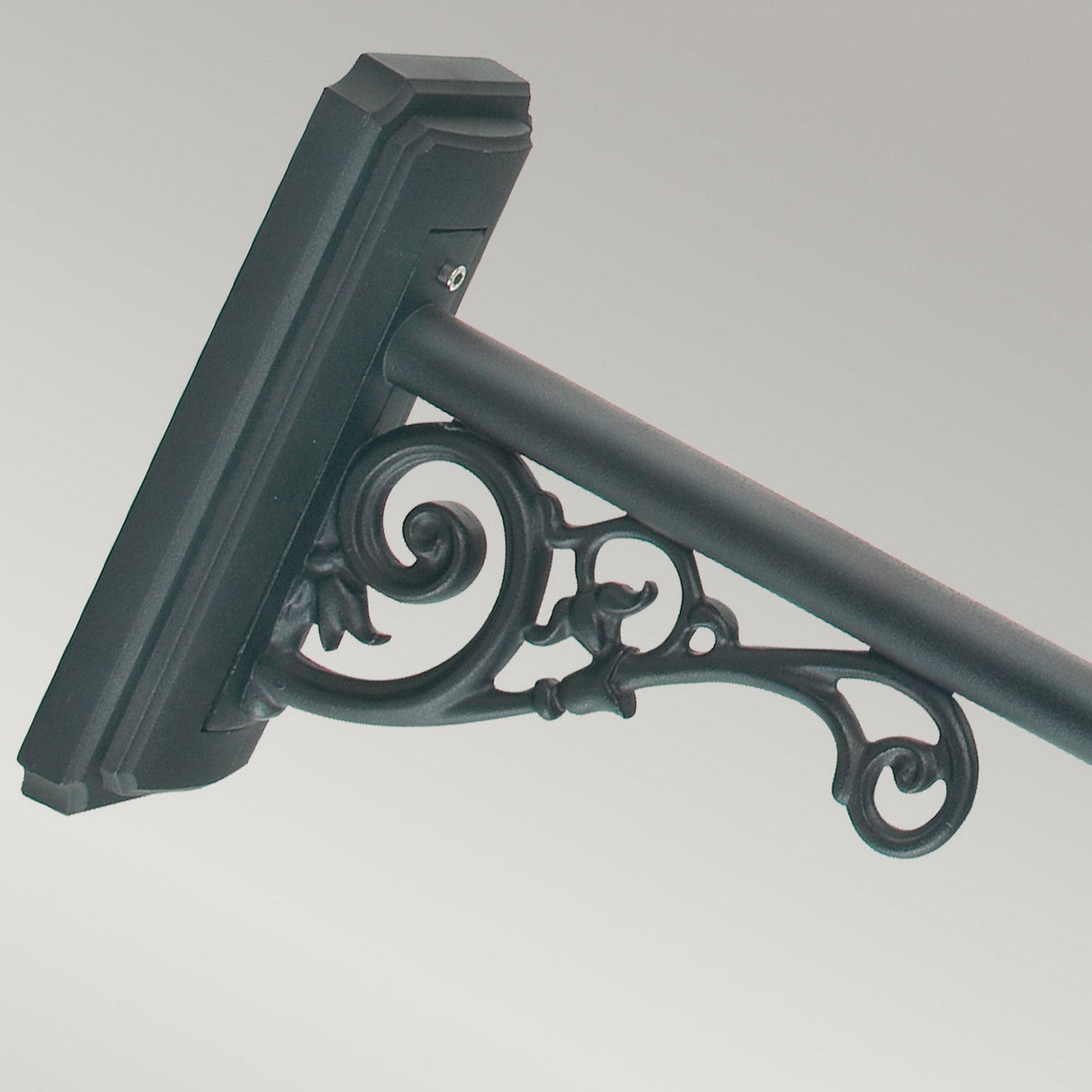 The Chelsea Outdoor 1 Light Grande Up Wall Lantern in copper features ornate scrollwork, reminiscent of an antique design, making it perfect for supporting a rectangular frame to house a sign or display board against a neutral gradient backdrop.