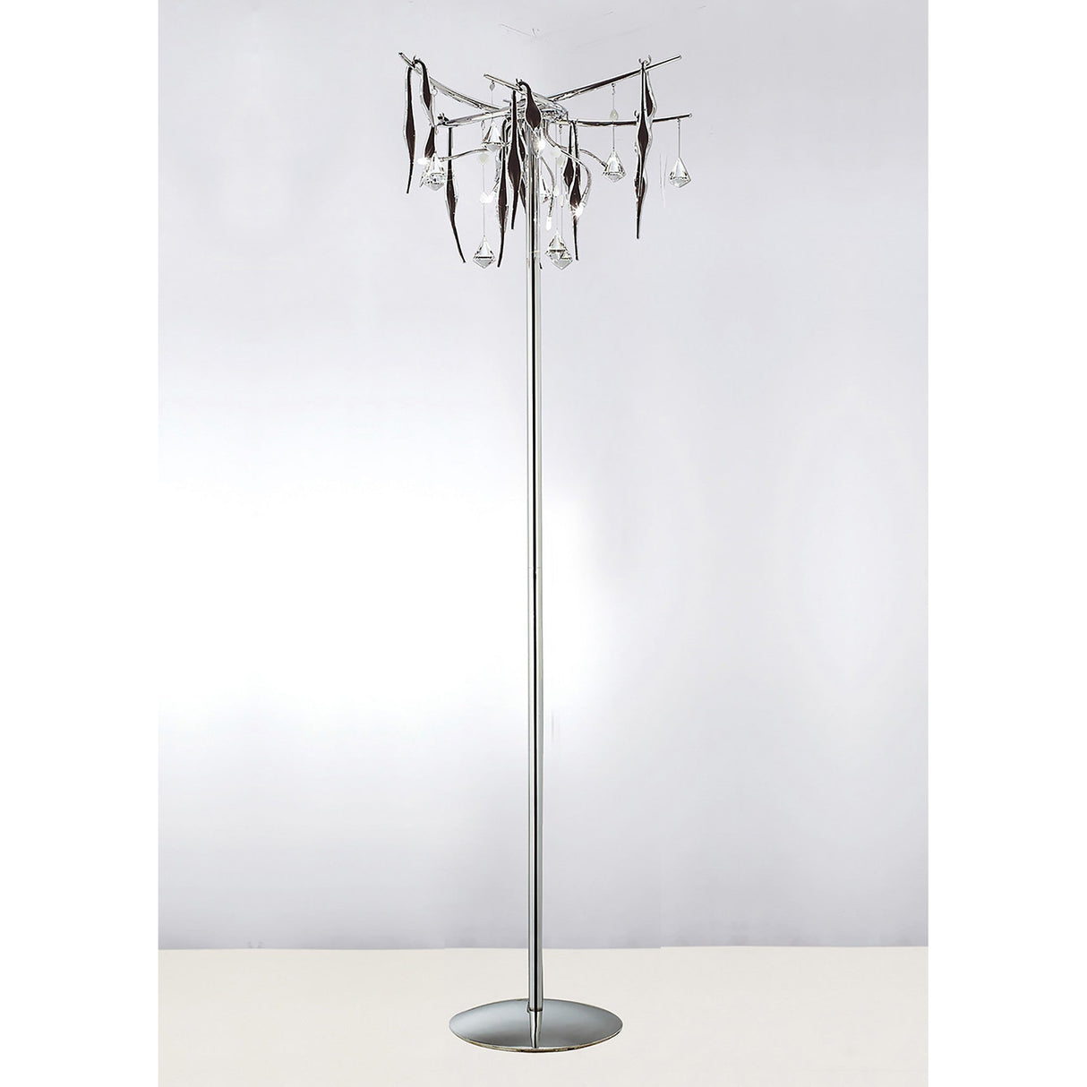 The Cygnet 6 Light Glass & Crystal Floor Lamp in chrome features a slim metallic pole, circular base, and chandelier-style top with hanging glass droplets and decorative metal accents.