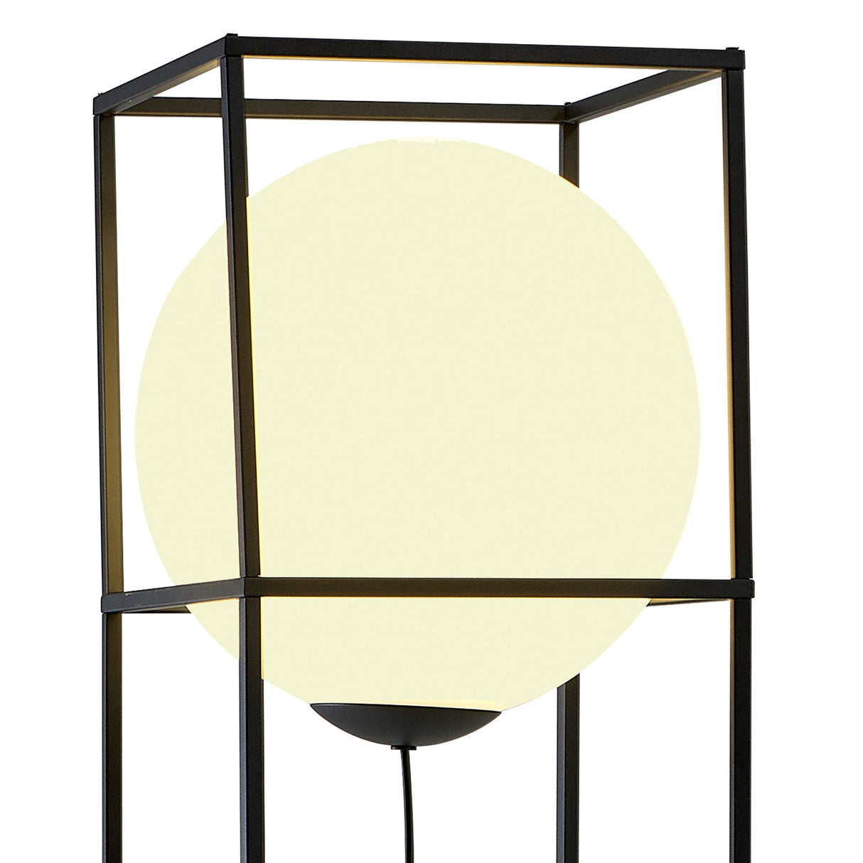 The Desigual Large 1 Light Floor Lamp in Matt Black features a glowing spherical shade within a black cube metal frame, showcasing contemporary minimalism. Its exposed cord adds to its modern, ambient style.