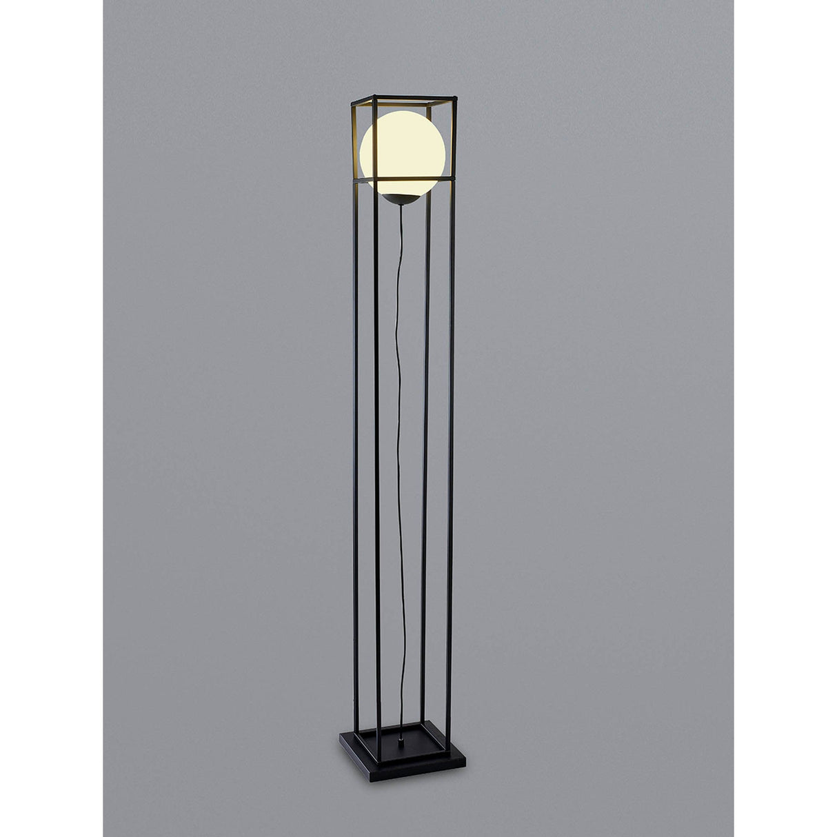 The Desigual Small 1 Light Floor Lamp in matt black features a modern square geometric frame with a glowing spherical bulb suspended at the center and a visible cord, all set against a plain gray background.