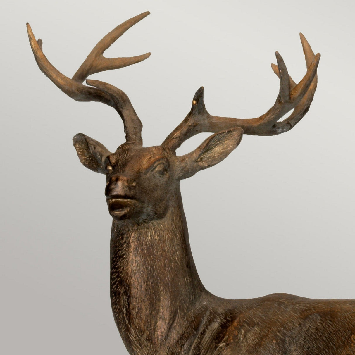 A meticulously crafted Amelia-1 Table Lamp With Oval Shade, featuring an exquisite bronze patina, is elegantly positioned against a simple gray background.