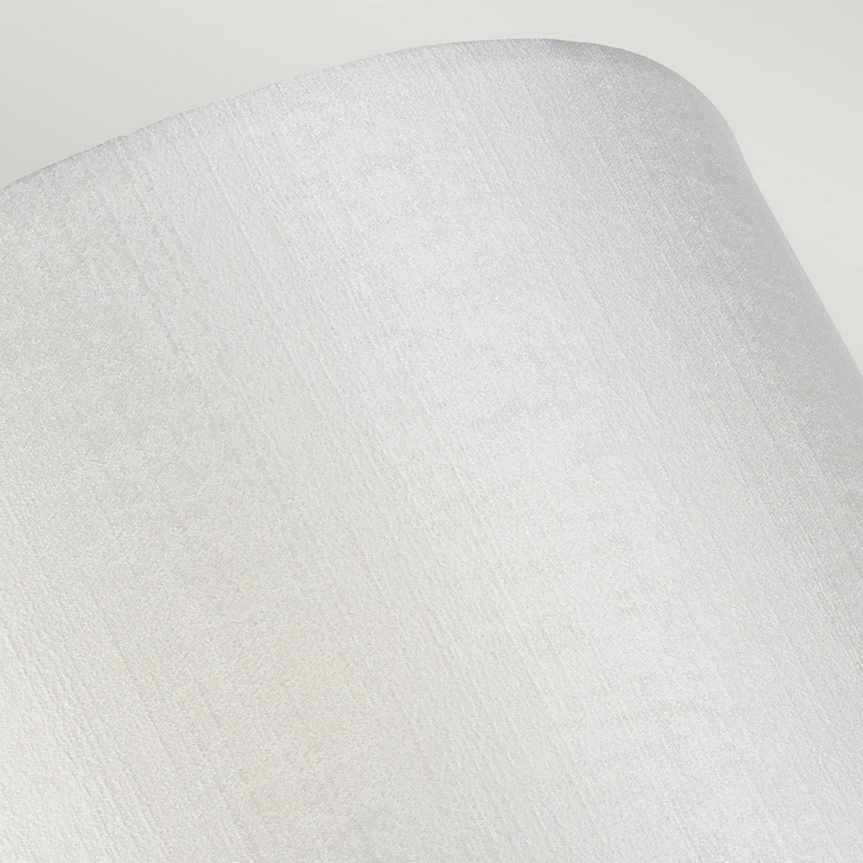 Close-up of the Cooper Small Curved Wall Light in polished chrome, showcasing its light grey, cylindrical design. The surface is smooth and softly reflects light, with a focus on the subtle vertical lines that mimic those in modern wall lighting.