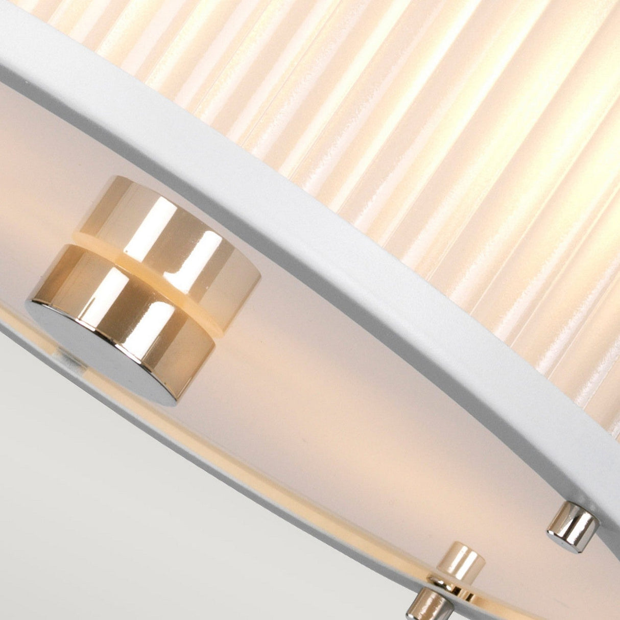 Close-up of the Corona 2 Light Pendant / Semi-Flush in White Satin featuring a pleated fabric shade and metallic accents. The pendant casts a warm glow that accentuates the texture of the shade, offering a sleek and contemporary design.