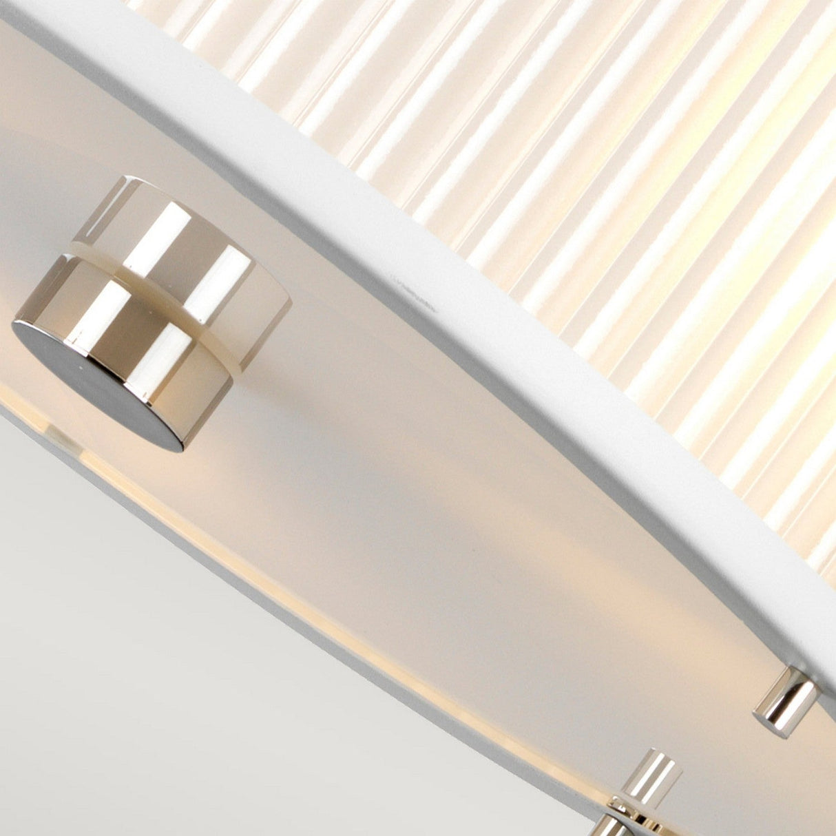 Close-up of the modern Corona 3 Light Pendant / Semi-Flush - White Satin, showcasing its sleek cylindrical shape with a sophisticated blend of white satin and chrome accents. This contemporary fixture casts a warm glow, adding elegance to any space.