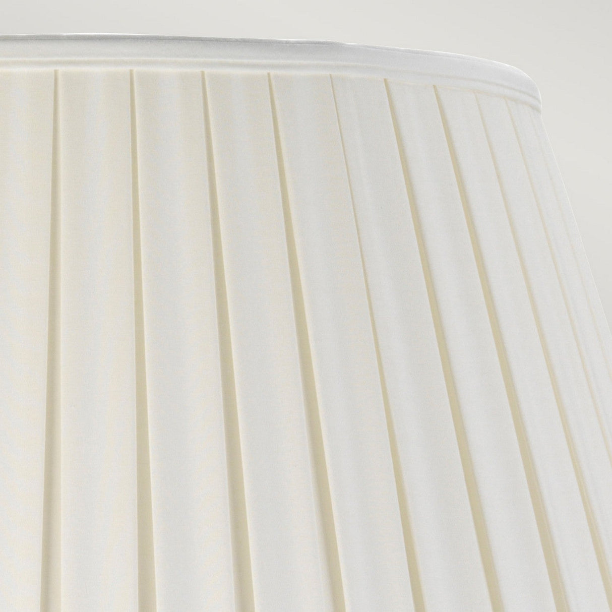 Close-up of the Dalian Table Lamp featuring a Tall Empire Shade in Celadon. The white, pleated fabric creates graceful vertical lines, giving it a timeless and classic appearance.