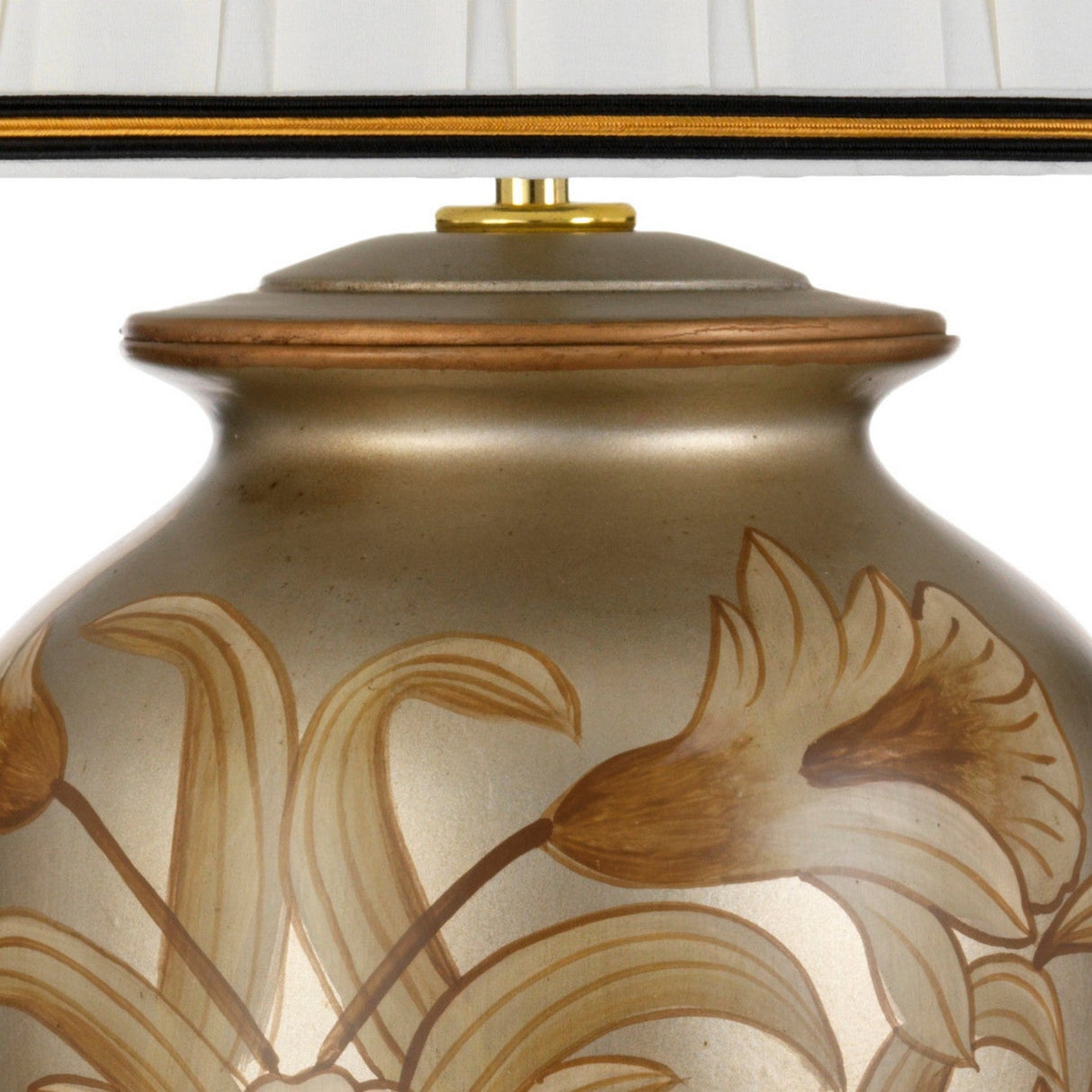 A close-up of the Dian Table Lamp with Tall Empire Shade - Silver & Gold reveals a decorative base with a golden floral design. The lamp's body resembles an oriental ceramic vase, featuring a metallic sheen and intricate flower patterns, topped with the edge of a tall empire shade in white pleats.