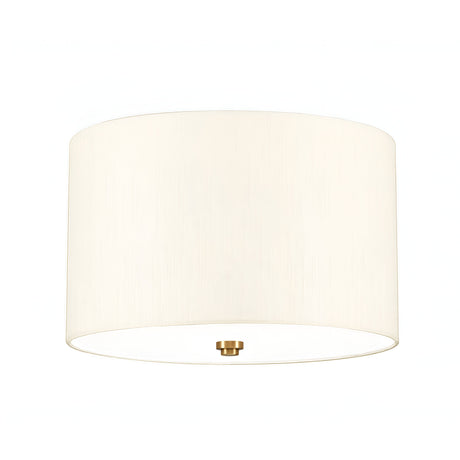 The Fletcher 14" Flush features a clean cylindrical design with an ivory faux silk shade and a small, round fixture finished in aged brass at the bottom center. The light is off, displayed against a white background which subtly highlights its flush mount design.