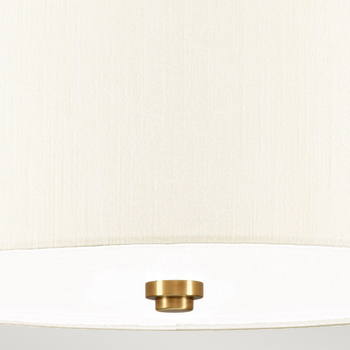 Close-up of the textured ivory shade on the Fletcher 14" Flush - Aged Brass with Ivory Shade, showcasing a subtle brass detail at the center bottom. The image emphasizes the fabric and the lampshade's minimalist flush mount style.