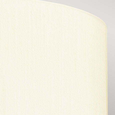 A close-up of the Fletcher 22" Flush with its polished chrome base and an ivory shade shows off a textured cream-colored surface with a rounded edge against a lighter gray background. The lighting, evocative of modern interior designs, highlights the texture, lending the surface a soft and subtle appearance.