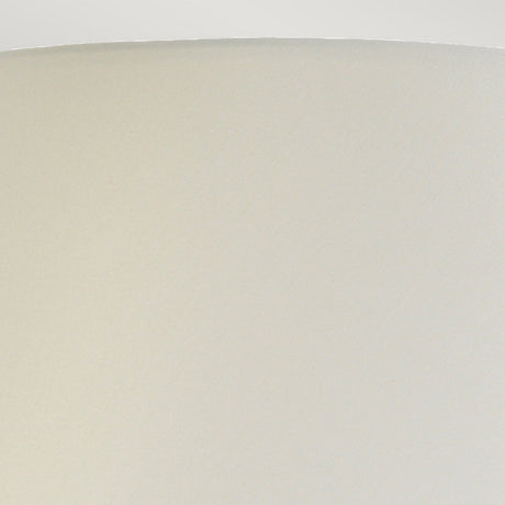 Close-up view of a simple, light beige lampshade with a textured surface. The top edge is smoothly rounded, forming a gentle arc against a plain white background, reminiscent of the elegant design found in the Harbin Gourd Table Lamp With Tall Empire Shade in Duck Egg Blue.
