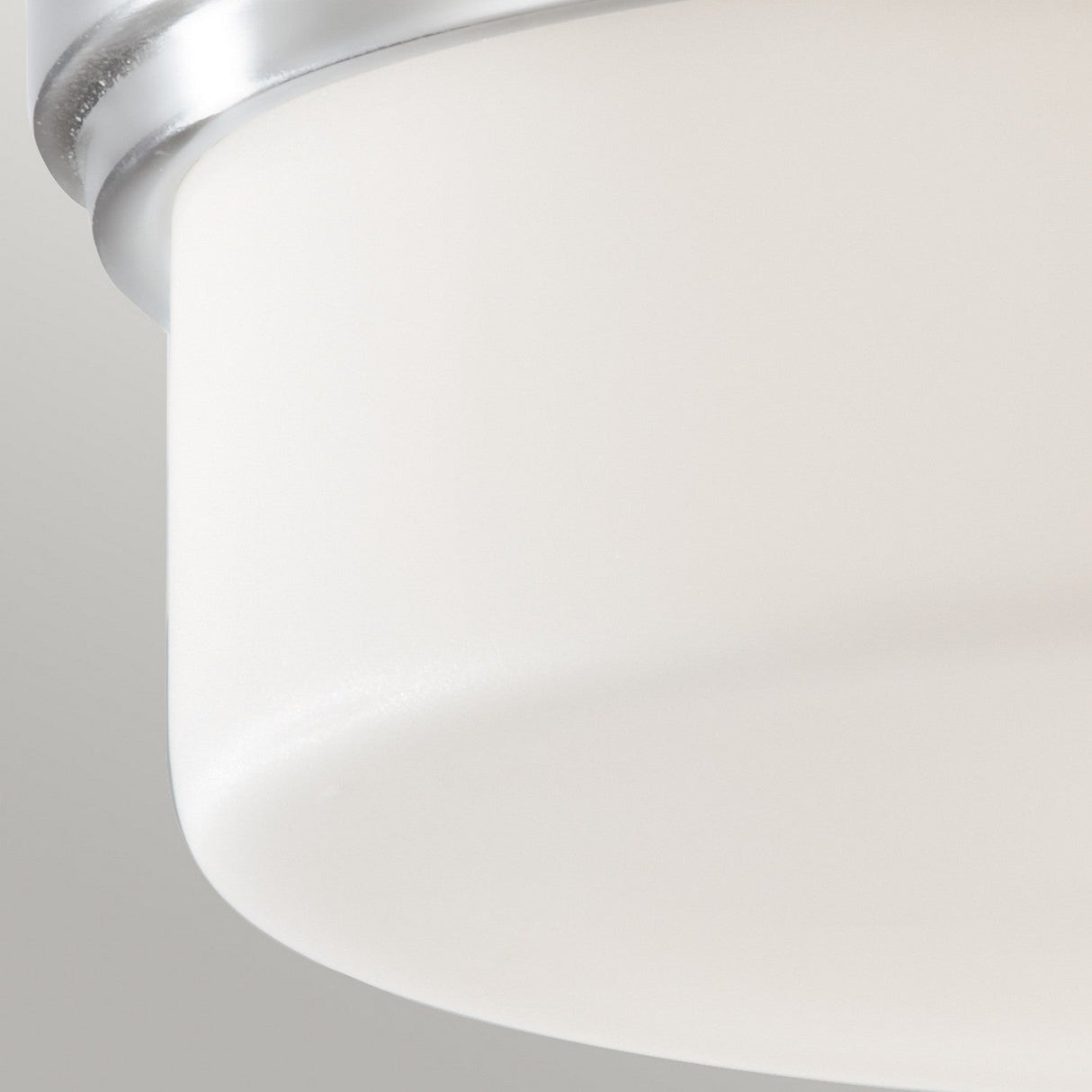 A close-up of the Kincaid 2 Light Flush fixture, featuring an opal-etched glass shade and a polished chrome rim. The fixture is mounted on a light-colored ceiling, highlighting its clean and minimalist design.