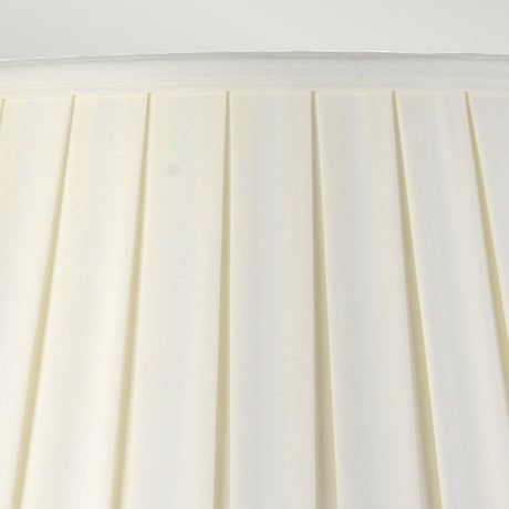 Close-up of the Linyi Table Lamp's tall empire shade, featuring off-white pleated fabric with a simple yet elegant design. The pleats add a subtle texture to the surface, giving the lampshade a classic look that beautifully complements its ceramic base and matches any blue and white lamp ensemble.