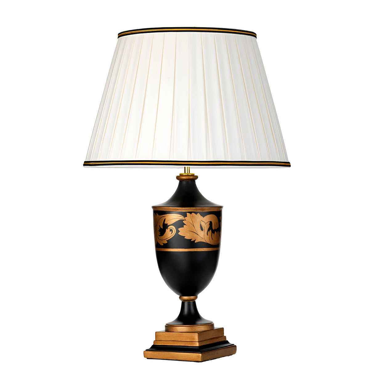 The Narbonne Table Lamp - Black & Gold is a sophisticated lighting fixture showcasing a white pleated lampshade and an ornate base with black and gold leaf patterns atop a square, layered pedestal, embodying classical beauty and timeless elegance.