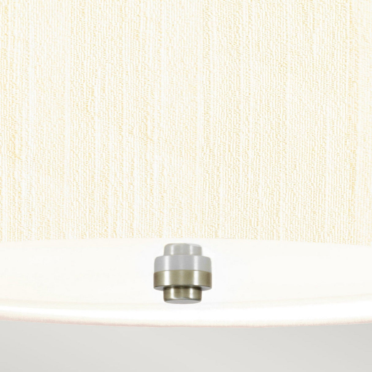 Close-up of a white ceiling showcasing the Pearce 14" Pendant Light with its small, dome-shaped design in polished chrome. The background is adorned with textured beige wallpaper, enhancing the lighting fixture's sleek elegance and modern charm.