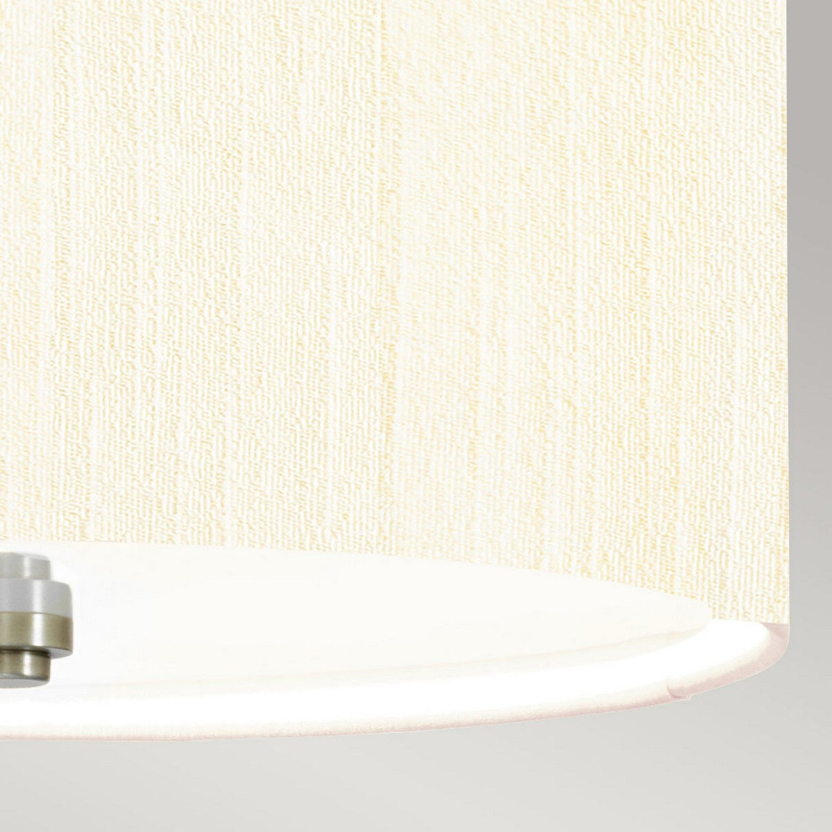 Close-up of the Pearce 14" Pendant Light, featuring an ivory textured lampshade. Its circular white base and polished chrome accents are partially visible against a light gray background.