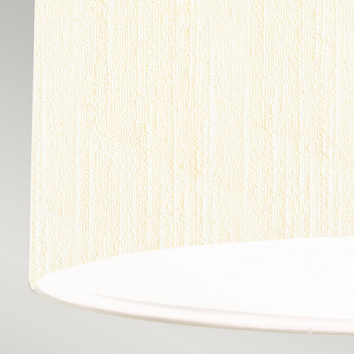 Close-up of the Pearce 18" Pendant Light's ivory lampshade, featuring a textured fabric surface that epitomizes modern design. The image highlights the bottom right portion of the polished chrome fixture, showcasing its rounded edge against a light gray background.