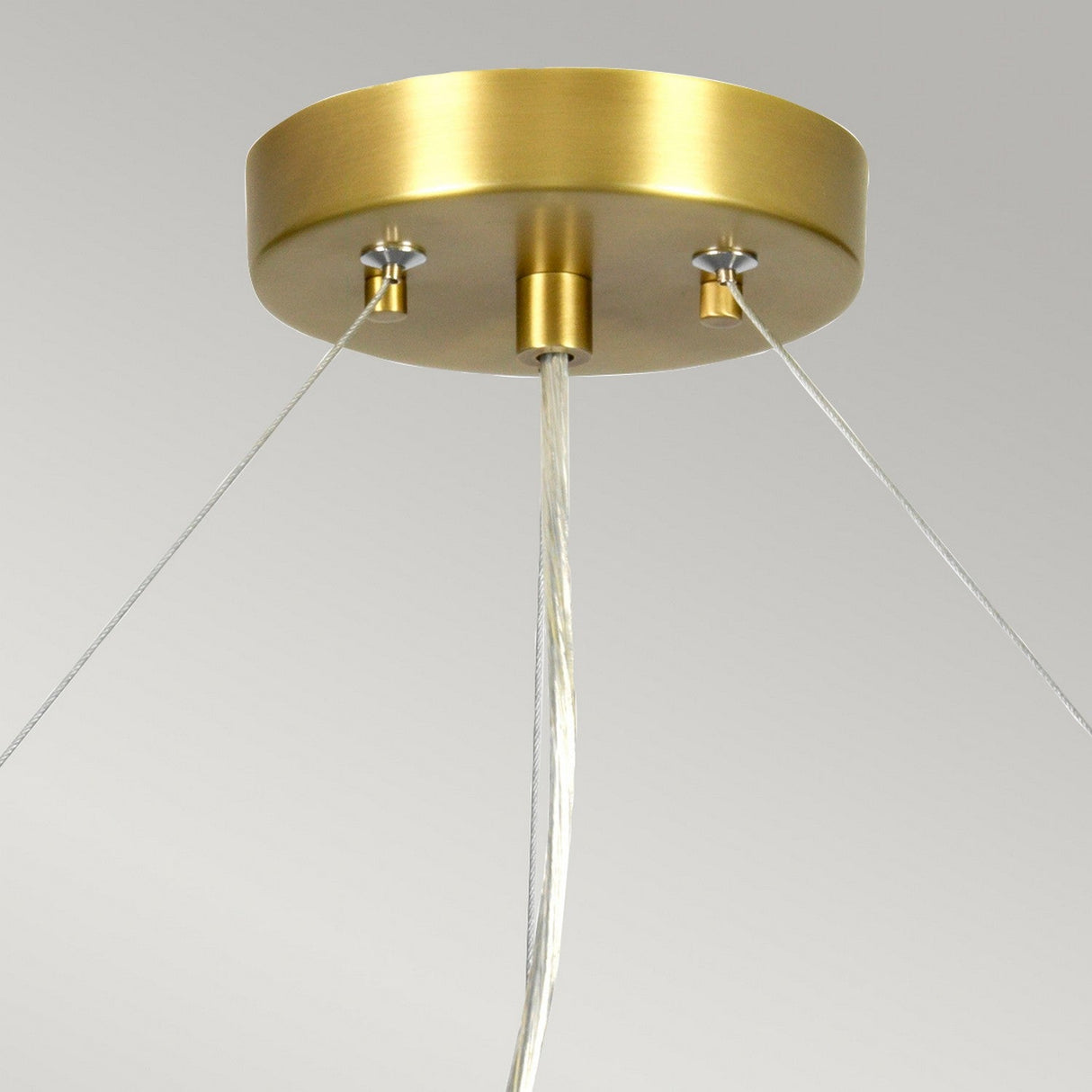 The Pearce 26" Pendant Light features an aged brass metallic base and an ivory shade. It is suspended from the ceiling by three wires, set against a neutral gray background that accentuates its sleek and minimalist design.