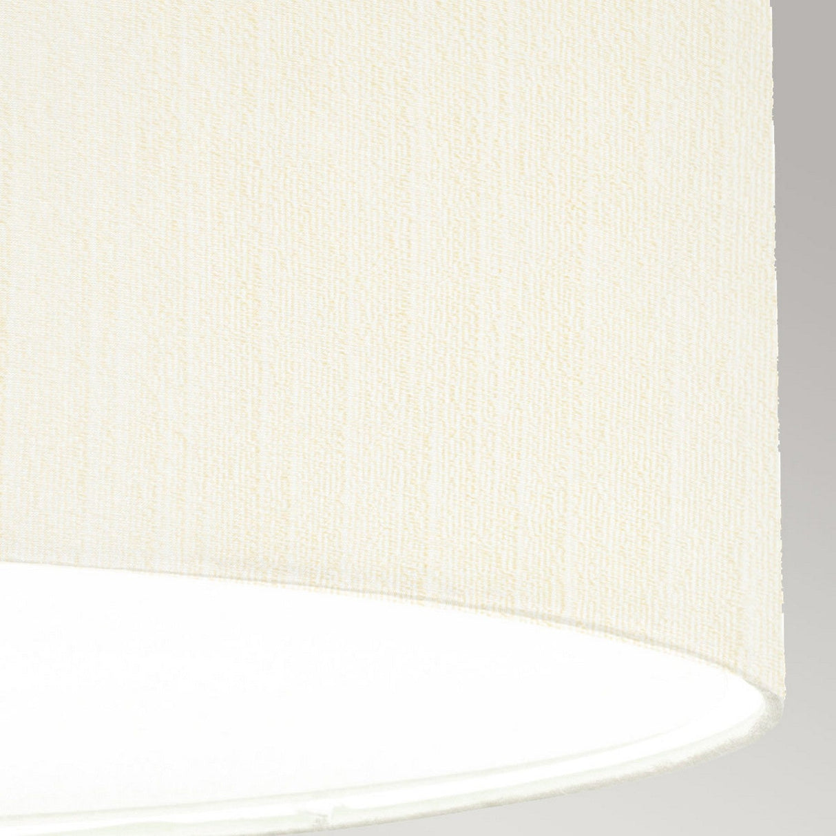 Close-up of the Pearce 26" Pendant Light featuring an ivory fabric shade overhanging a bright white light, ideal for modern interiors. The texture offers a soft, diffused glow, complemented by polished chrome accents for added elegance. The soft gray background enhances the warm tones of this pendant light.
