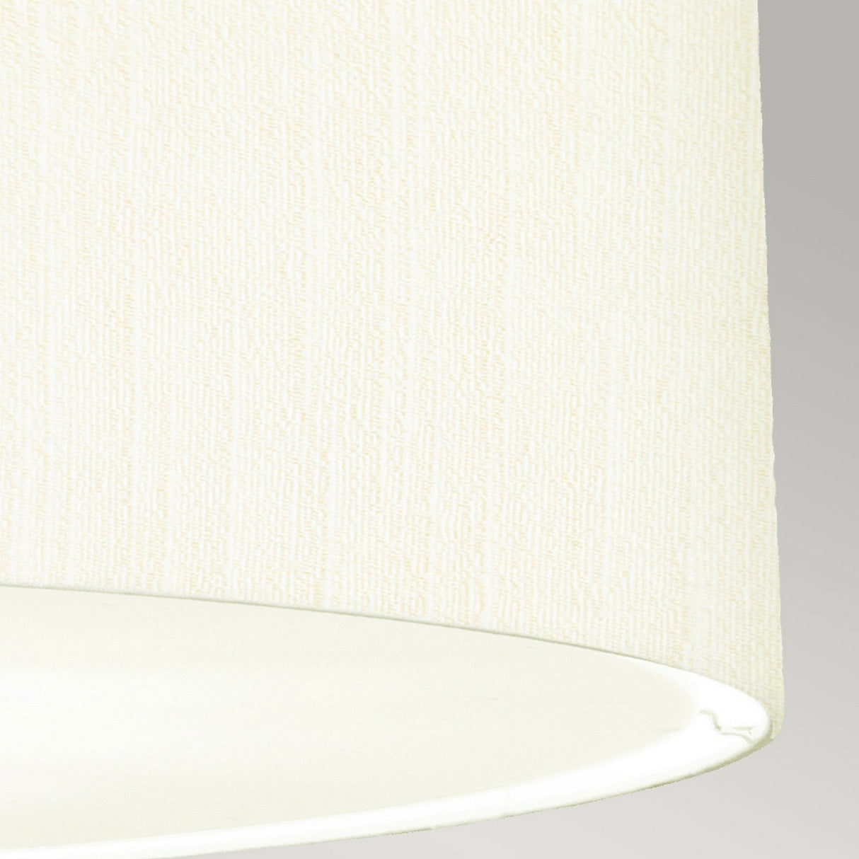 Close-up of a Pearce 30" Pendant Light with an ivory shade that features a subtle textured pattern, set against a light gray background. The bottom edge of the shade is slightly visible, emphasizing its cylindrical shape and polished chrome accents, epitomizing modern lighting elegance.
