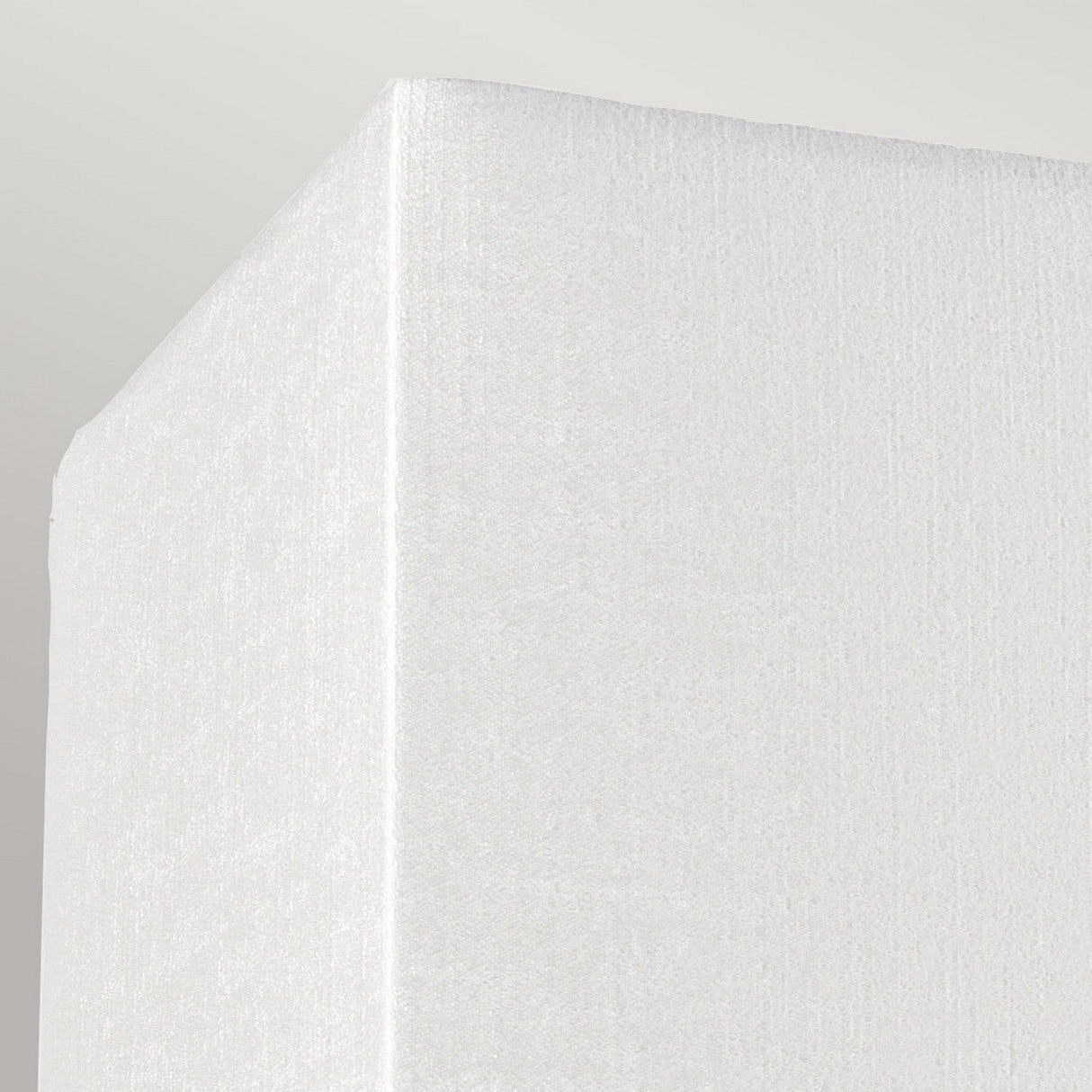 Close-up of the Riley Large Rectangular Wall Light in polished chrome against a light gray background. The sleek finish is visible, embodying the essence of contemporary design with its smooth and clean appearance.