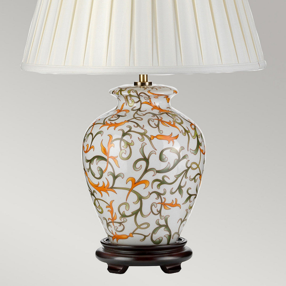 The Soling Table Lamp - Cream With Orange & Green embodies oriental craftsmanship, boasting a white shade atop a dark, round base. Its ceramic body displays intricate orange and green swirling vines set against a sleek, neutral backdrop.