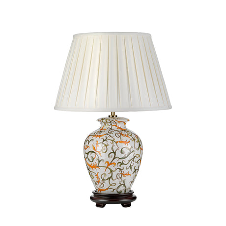 The Soling Table Lamp - Cream With Orange & Green showcases a decorative table lamp with a white pleated shade, flaunting a floral-patterned ceramic base inspired by oriental artistry, featuring vibrant orange, green, and brown hues. This elegant design is beautifully complemented by its dark wooden stand.