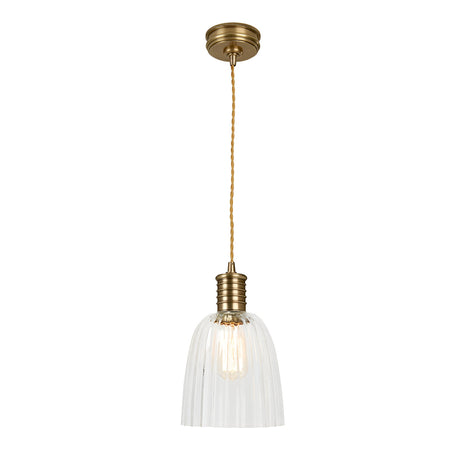 The Douille 1 Light Pendant in aged brass features a gracefully suspended design with a twisted cord. Its clear ribbed glass shade reveals an exposed bulb, beautifully complemented by LED filament lamps, creating an elegant and timeless look.