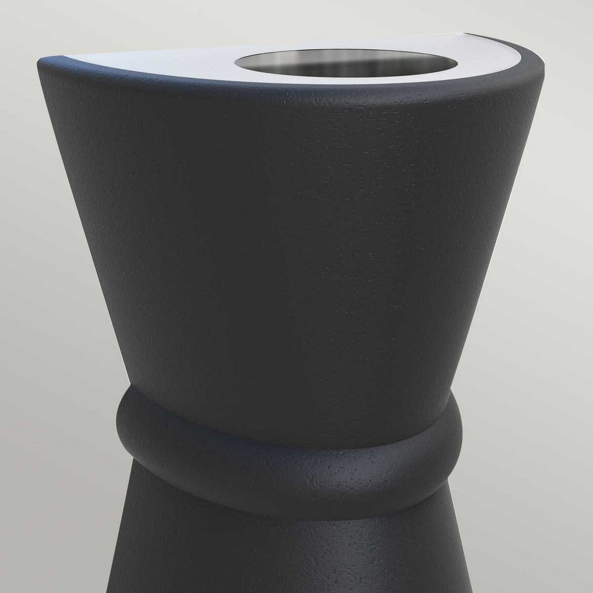 A detailed look at the sleek and stylish Dungarvan 2 Light Outdoor Up & Down Wall Light in black, which boasts an hourglass shape, a smooth texture with UV resistance, and features a top section with a white rim and circular opening.