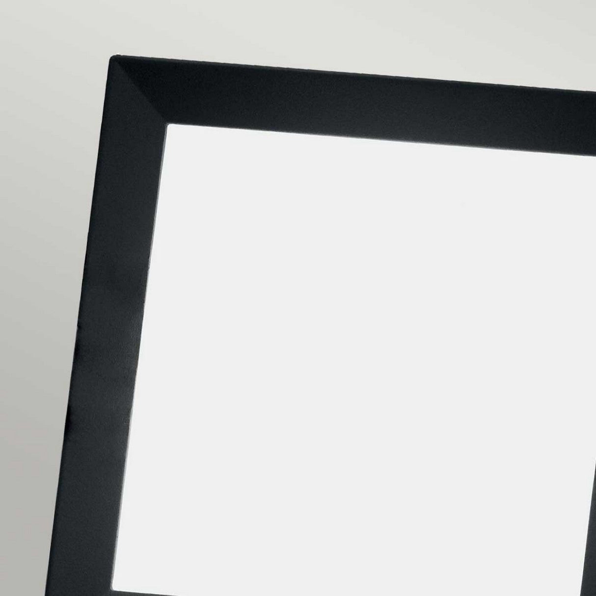 A close-up of the Egil-1 Outdoor Wall/Ceiling Light showcases its modern design, featuring a black-framed square light panel against a plain background. Made from cast aluminium with a graphite finish, this light panel emits a bright, even white light that elegantly contrasts with its sleek black border. Ideal for use as an outdoor wall light.
