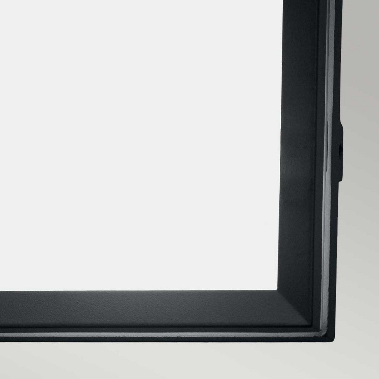 Close-up of the Egil-1 Outdoor Wall/Ceiling Light, highlighting its elegant black frame with a graphite finish surrounding a simple, light-colored display. The minimalist design of the material evokes the refined look of cast aluminum, drawing attention to the sleek sophistication of its contours.