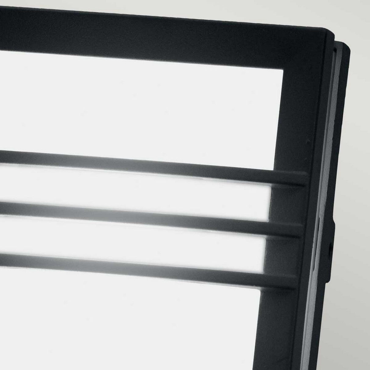 Close-up of the Egil-2 Outdoor Wall/Ceiling Light in graphite, featuring a modern LED panel with a sleek black frame and horizontal bars that highlight its minimalist design. Brightly lit against a neutral background, the cast aluminum structure underscores its elegant simplicity.