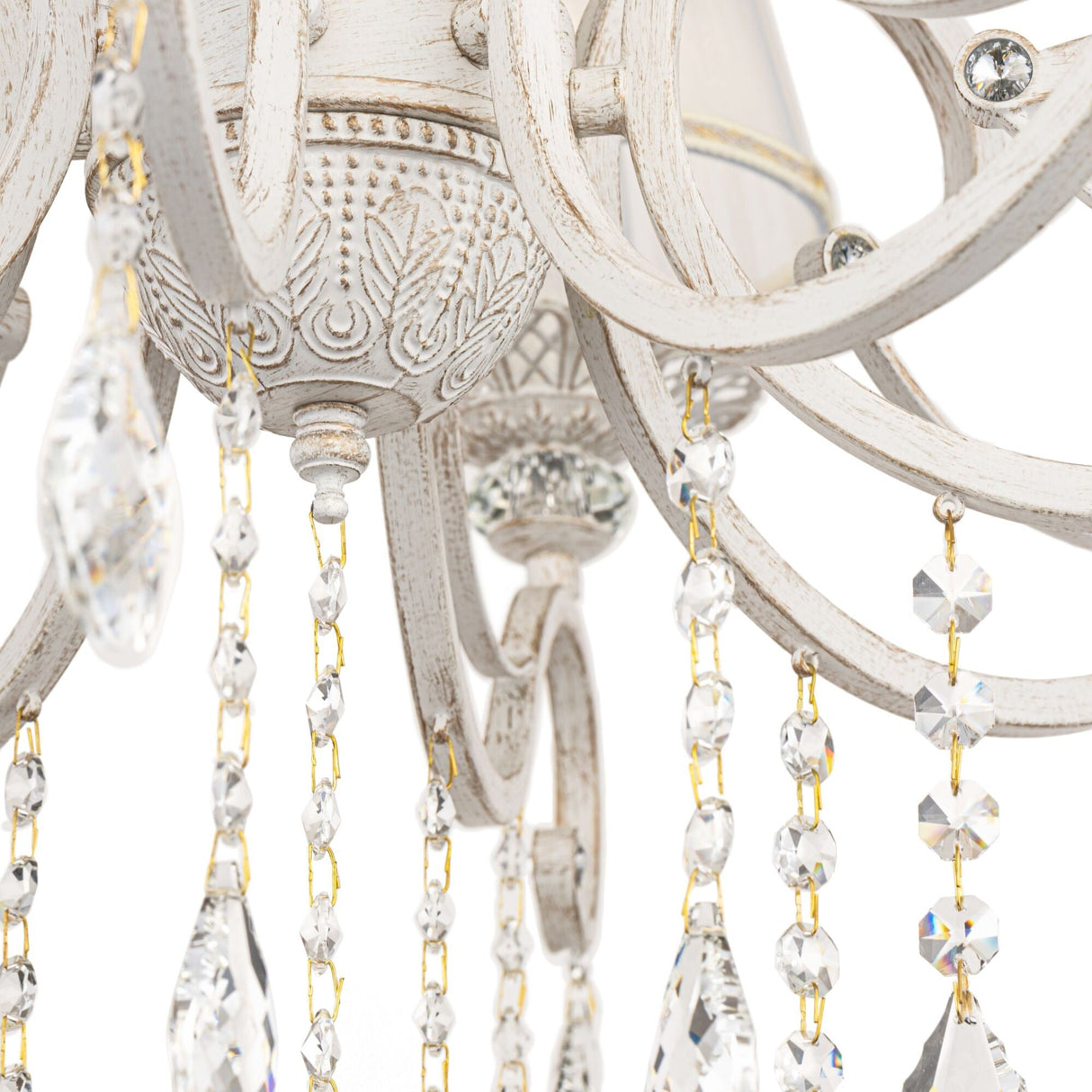 Close-up of the Grace 10 Light Chandelier - White showcases its distressed finish, intricate carvings, and vintage elegance enhanced by hanging crystal beads and teardrop pendants.